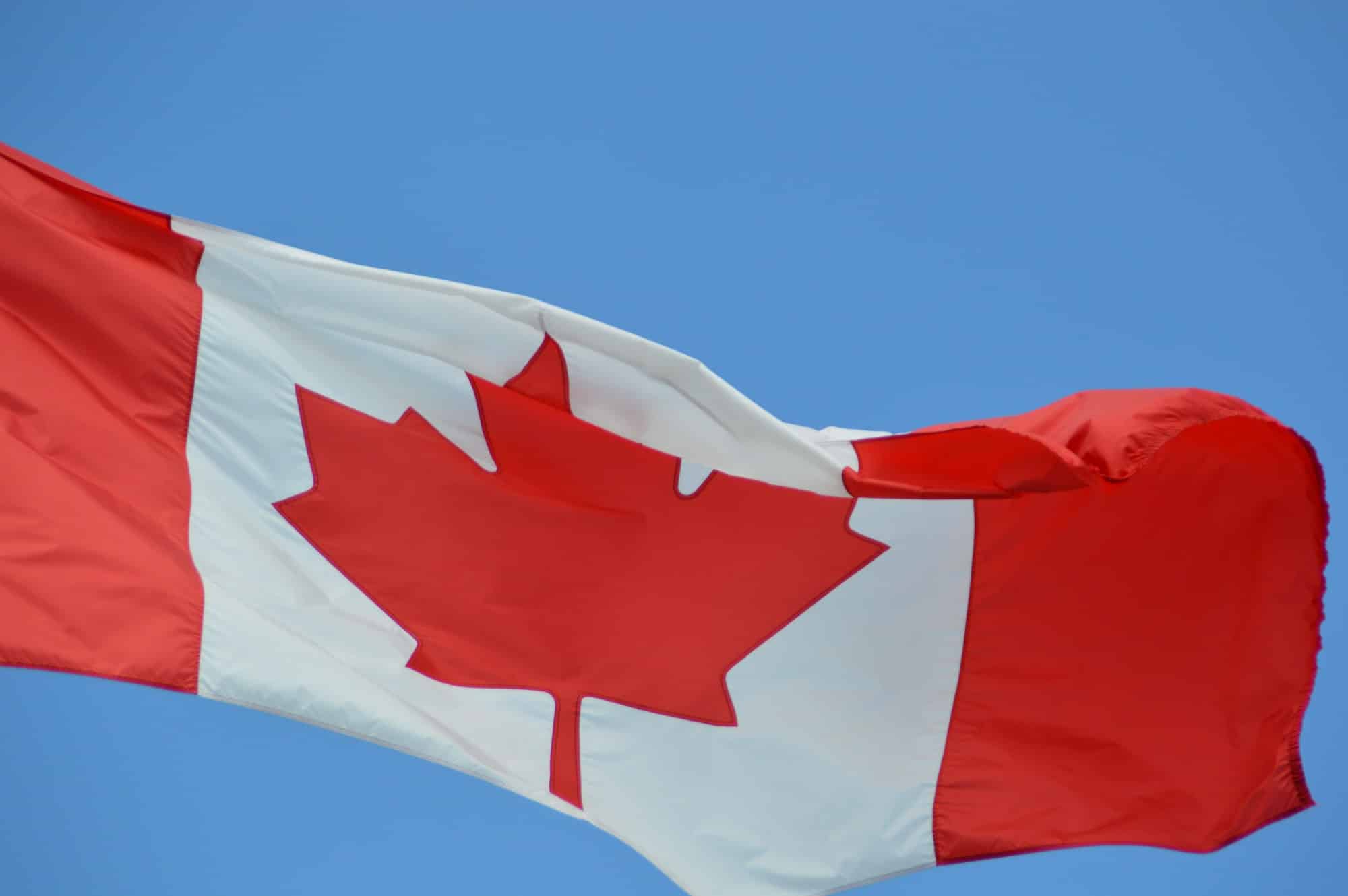 Canada flag against blue sky